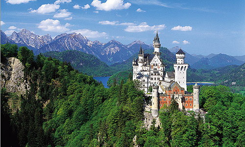 perfect 3 days in munich: The majestic neuschwanstein castle tours in center of green hilly landsscape and the sea at the back