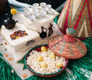 best 2 days tour in ethiopia- Ethiopian coffee ceremony articles white cups on white cupboard,black kettle, popcorn